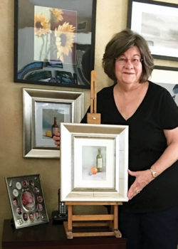 Pastellist Nancy Stifter with several of her paintings