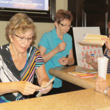 Kare Bears volunteers, left to right: Fran Wiley, Barbara Risden and Gladys Mabey staff the Awards Luncheon ticket sales operation.