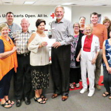 Red Cross staff and volunteers gathered around to applaud PebbleCreek’s donation as Kare Bears President Teri Sellers presented checks totaling $5,160 to Red Cross Chief Development Officer Don Speck.
