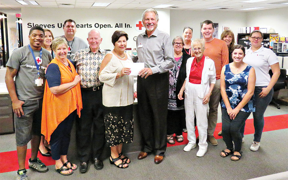 Red Cross staff and volunteers gathered around to applaud PebbleCreek’s donation as Kare Bears President Teri Sellers presented checks totaling $5,160 to Red Cross Chief Development Officer Don Speck.