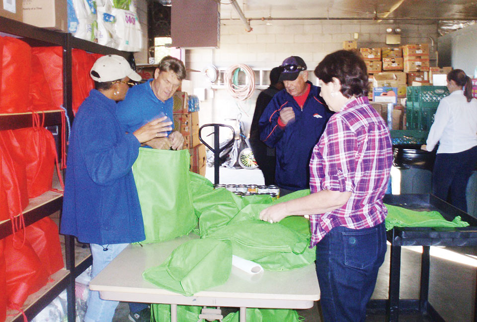 Volunteers fill holiday bags with dinner items at Agua Fria Food and Clothing Bank.