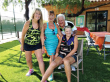 Tennis club members Vikki Constable, Susie Anderson, Jerry Santy and Suzanne Schultz relax after a club mixer as Vikki and Suzanne show the knee surgeries that will get them back on the courts soon.
