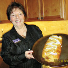 Claudia Clarkson, President of Chapter P, showing what a beautiful pastry a Butter Braid is.