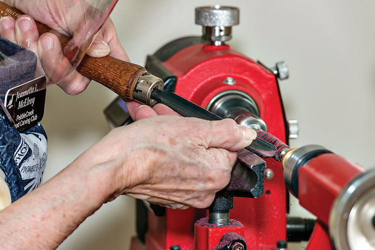 Figure 1: Jeannette McElroy working on the lathe.