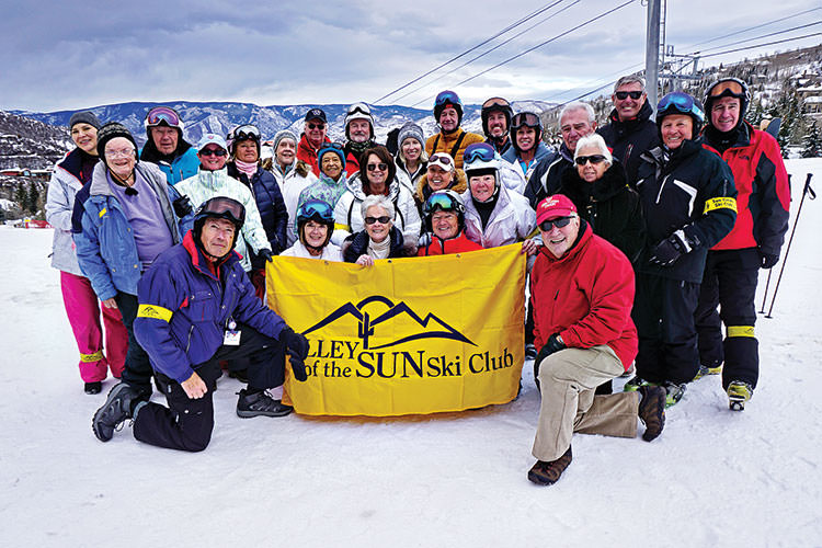 PC skiers Lynn Warren, Lew and Rose Geller together with other members of Valley of the Sun Ski Club pausing for a group photo with the Village Lift at Snowmass (Aspen) in the background; photo by Mary Ann Vangelisti.