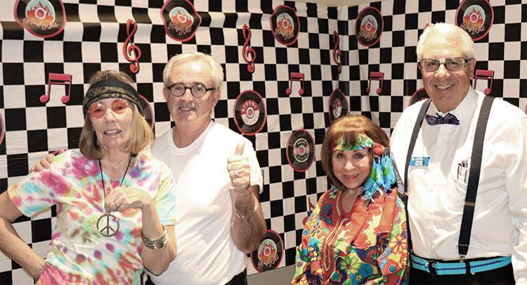 Judy and Ross Hart and Frankie and Chuck Veltri get in the ’60s spirit to help promote the upcoming Blast Back to the Past dinner, dance, musical extravaganza; Photo by Phil Korzilus.
