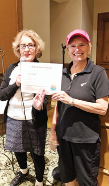 PCL9GA President Barbara Hockert presenting Carol Miller with a hole-in-one certificate.