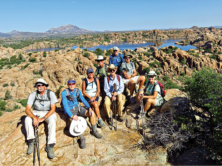 Left to right: Wayne McKinney, Lynn Warren (photographer), Marilyn Reynolds, Dave Ausman (“Ausy”), Pete Williams (hike leader), Ed Bobigian, Diana Bedwell and Mary Hill relaxing in the Granite Dells high above Watson Lake with Granite Mountain in the background.