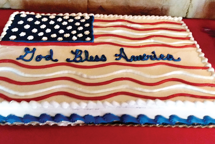 Barb Guthier and Barbie Bennewate, who checked in members and guests, toasted our president. An American flag carrot cake was a special treat after dinner and during the president's announcement.