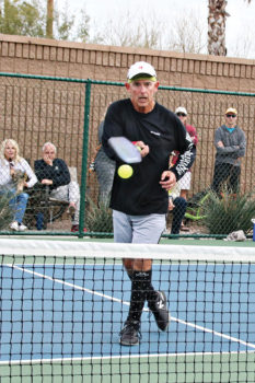 Jim Barbe slips the ball over the net. Photo by Dannie Cortez.