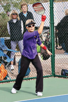 Lynn Lionhardt smashes a serve. Photo by Dannie Cortez.