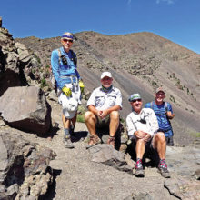 Left to right: Lynn Warren (photographer), Neal Wring, Bill Halte, and Clare Bangs pausing for a group photo at the 11,800 foot saddle with Humphrey’s Peak in the background.