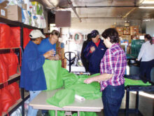 PCCC volunteers filling holiday bags with dinner menu at Agua Fria Food Bank.