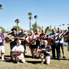 Some of the participants in the upcoming Folk Festival. Standing (left to right): Jack Mateer, Alan Hoxie, Mike Caswell, Holly Carrier, Gary Kotula, Dave Silverstein, Carl Halladay, John Flynn, and Carlos Taylor. Kneeling: Robert Hover and Gene Fioretti. Not pictured: Howard Brodbeck, Karen Follett, and Greg Davis. Photo by Jim Workman.