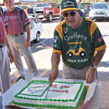 Bob Quarantino, one of the original players, is shown cutting the twenty-fifth-year anniversary cake.