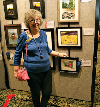 Marsha Lyons enjoys artwork at PCAC Fall show.
