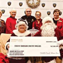 Back row (left to right): Wally Campbell; Suzanne Butler; Deputy Chief of Police Santiago “Jimmy” Rodriguez; Barbara Hockert, and Charlotte Krause; front row: Mrs. Claus and Santa
