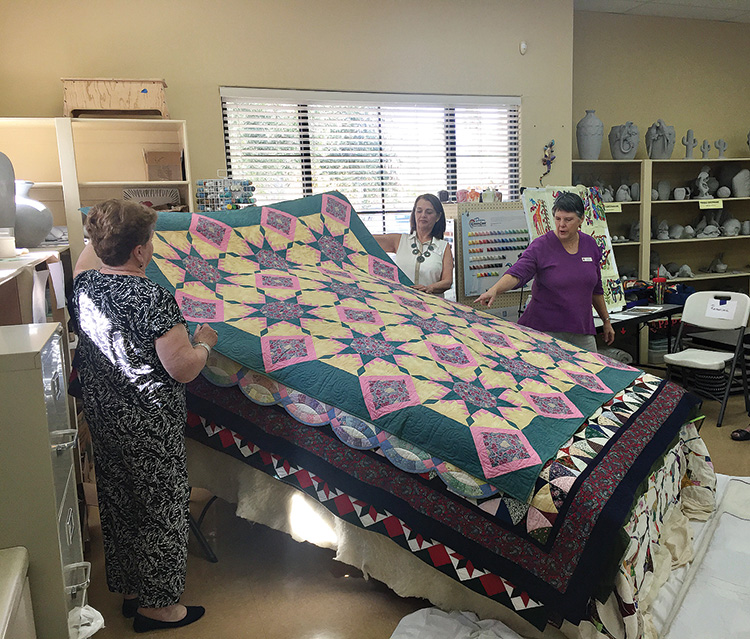 Karen Bogadi is conducting a 'bed turning' for the PC Quilters March 2018 Quilt Show. Karen, both a quilter and rug hooker, is showing the growth and stories of her quilt-making journey as each quilt is shown.