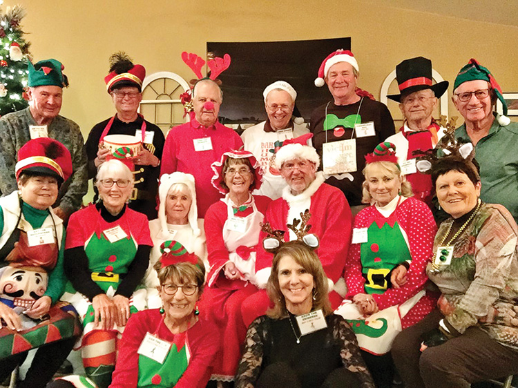 The Sunday Couples Golf Group celebrates by dressing up for a murder mystery. Back row: Angelo Fergione (VIP the Elf), Lloyd Chilton (Little Drummer Boy), Lee Kitchel (Rudy the Reindeer), Jerry White (Scrooge), Mike Dinan (Gingerbread Man), Al Carney (Icy the Snowman), Terry Johnson (Toymaker); Middle row: Liz Fergione (the Nutcracker), Barb Chilton (Dap the Elf), Virginia Kitchel (Polar Bear), Mary Barry (Mrs. Santa), John Barry (Santa), Kathy Carney (Pax the Elf), Sharon Johnson (Prisser the Reindeer); Front row: Sue White (Gab the Elf), and Jayne Dinan (Ozzy the Reindeer)