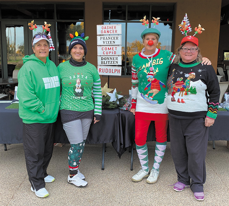 Three Reindeer Games co-chairs and Santa’s helper at the North Pole check-in desk