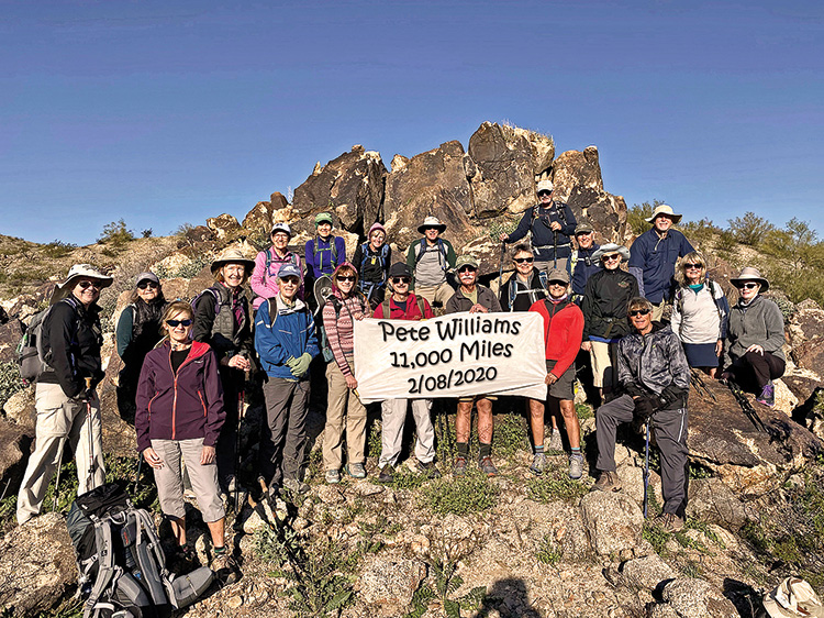 Left to right: Charlene, Pat, Laurie, Ann, Nadine, Kathleen, Kris, Tina, Eileen, Pete, Grant, “Ausy,” Diana, Dave, Ruth, Dennis, Betty, Julian, Ron, Nancy, and Pam pose on an interesting rock formation on Buckeye’s Dog Bone trail.