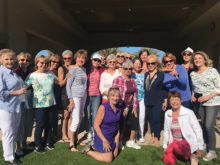 Members of her aerobics class gather round Ann Merrill (standing third from the right) at the Oasis Pool to celebrate her birthday.