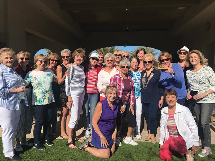 Members of her aerobics class gather round Ann Merrill (standing third from the right) at the Oasis Pool to celebrate her birthday.