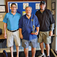 President Ray Clemens awards club champion, Fred Schmidt (right), and low net champion, Ray Bender (left).