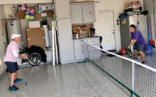 Renee deLassus and Andrea Dilger volley in the garage.