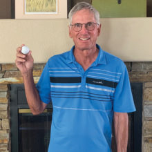John Curtin shows off his June 26 hole-in-one ball.