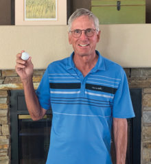 John Curtin shows off his June 26 hole-in-one ball.