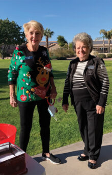 President Judy Maloney welcomes Wally Campbell at the Sunrise Park outdoor meeting.