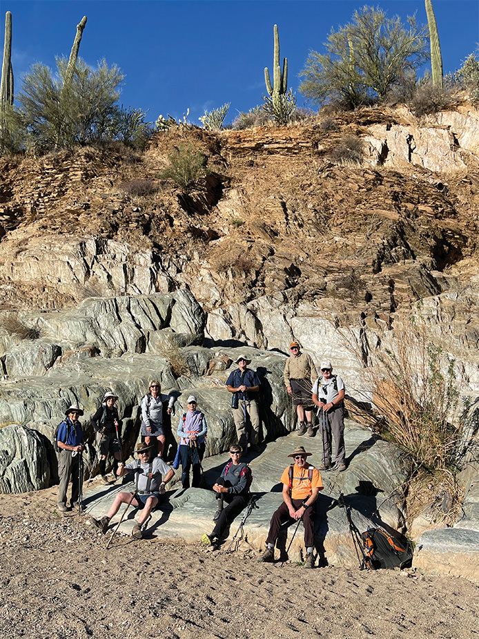 Some of the local geology. Hikers (from left to right): Art Arner, Charlene Elijew, Alex Elijew, Nancy Love, Jo Ann Talent, Mary Hill, Ron Grove, Gary Baker, hike leader Joe Clarkson, and Dave Schuldt. (Photo by Dana Thomas)