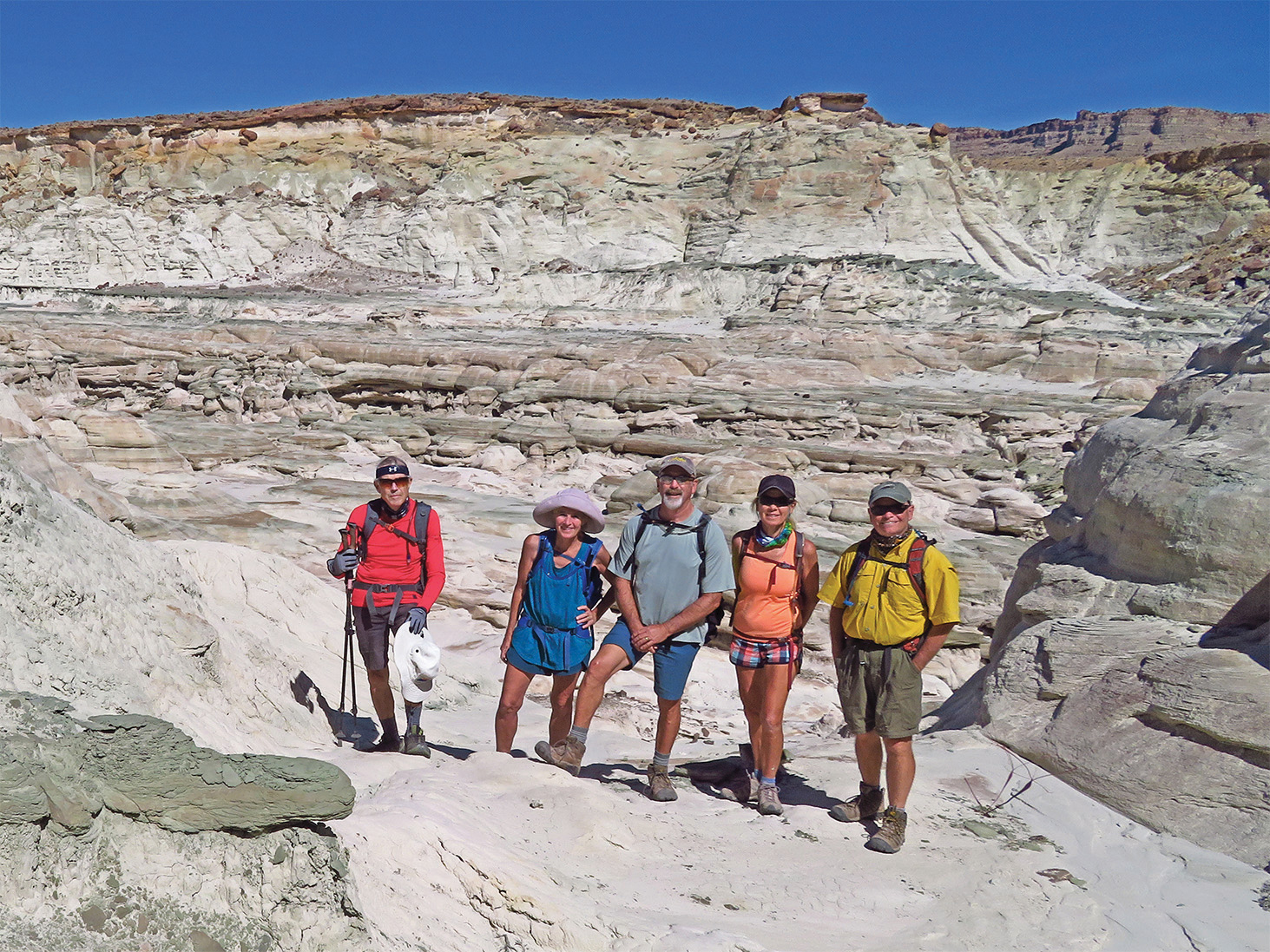 Left to right: Lynn Warren (photographer), Eileen and Leon Mosse, Kris Raczkiewicz, and Neal Wring enjoying a magical canyon with brilliant white rock formations in southern Utah.