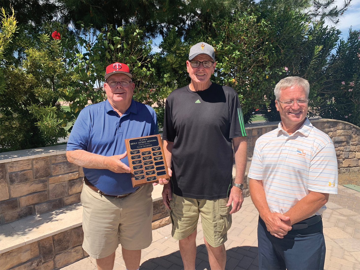 Bill Lansing, PCM9GA director of golf operations, presents the 2021 Men’s 9 Holers Low Gross Champion plaque to Fred Schmidt with Tuscany pro David Vader
