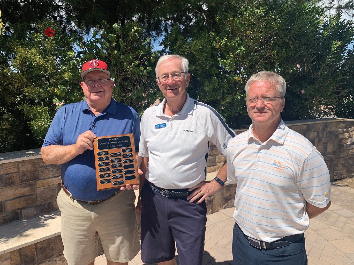 Bill Lansing, PCM9GA director of golf operations, presents the 2021 Men’s 9 Holers Net Champion plaque to Russ Georgesen with Tuscany pro David Vader