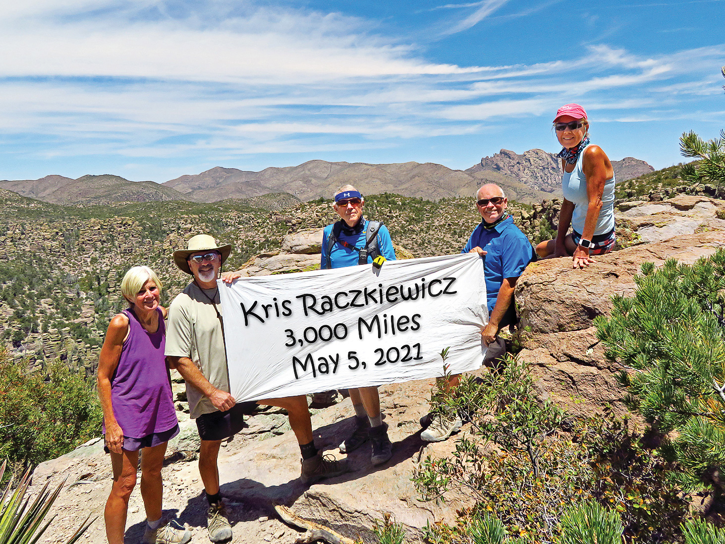 Left to right: Eileen and Leon Mosse, Lynn Warren (photographer), Neal Wring and Kris Raczkiewicz pause on Inspiration Point (with Cochise Head in the background) in the Chiricahuas to celebrate Kris’ achievement.